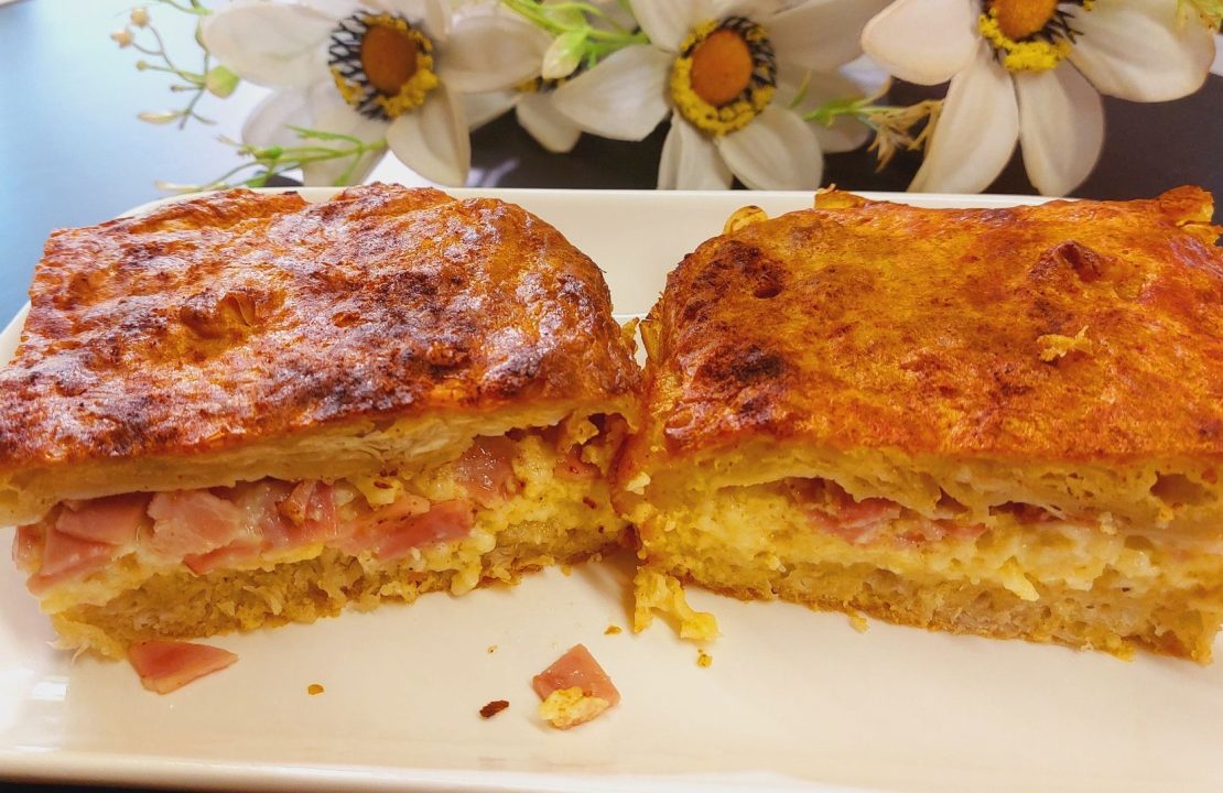 Two pieces of Greek ham and cheese pie on a plate