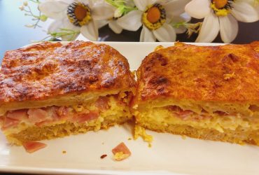 Ζαμπονοτυροπιτα -Two pieces of Greek ham and cheese pie on a plate