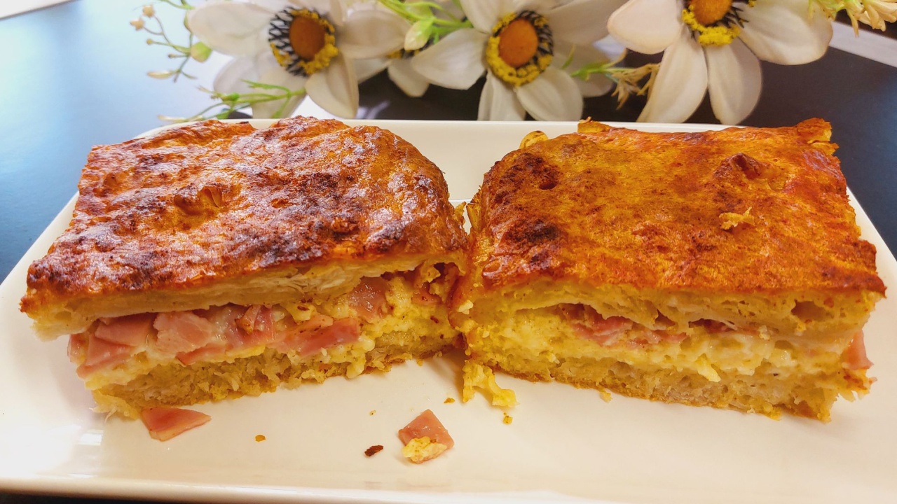 Ζαμπονοτυροπιτα -Two pieces of Greek ham and cheese pie on a plate