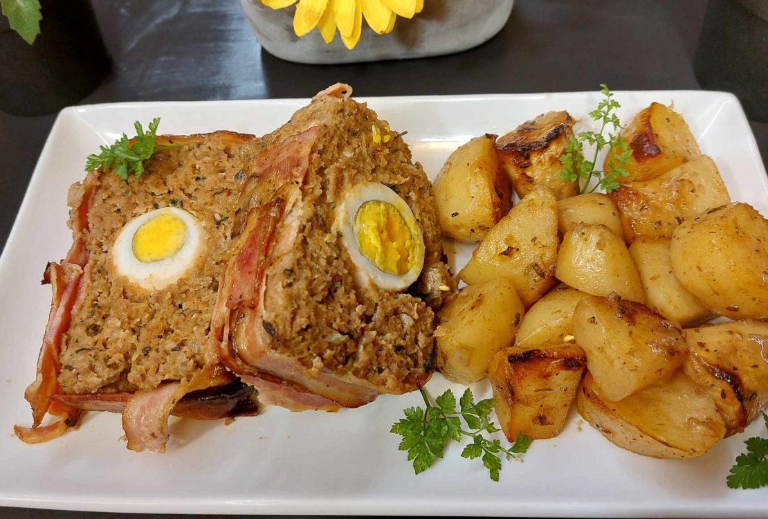 Egg stuffed meatloaf wrapped with bacon slices