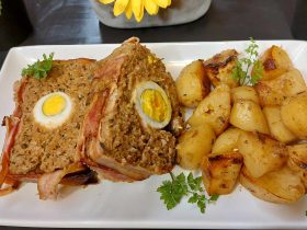 Egg stuffed meatloaf wrapped with bacon slices